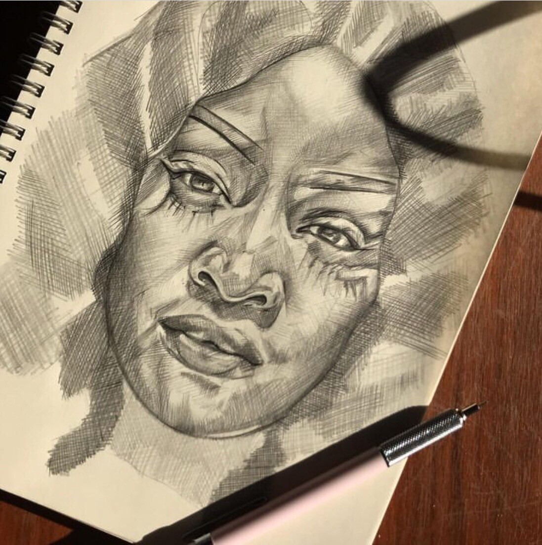 A graphite drawing in crosshatch-technique of a black woman looking directly at the spectator.