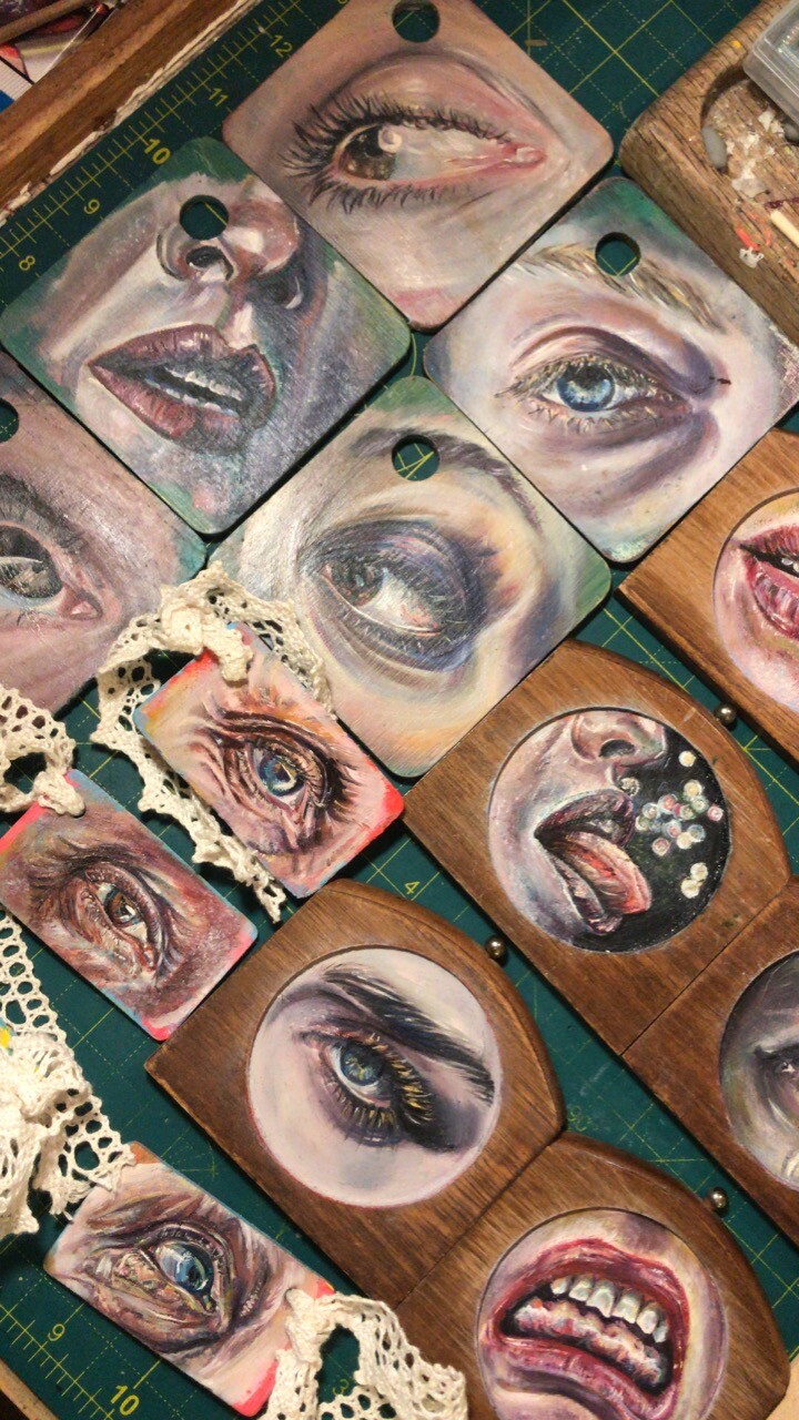 Small oilpaintings of different features on different types of wood. It’s eyes, mouths and noses in colorful oilpaint