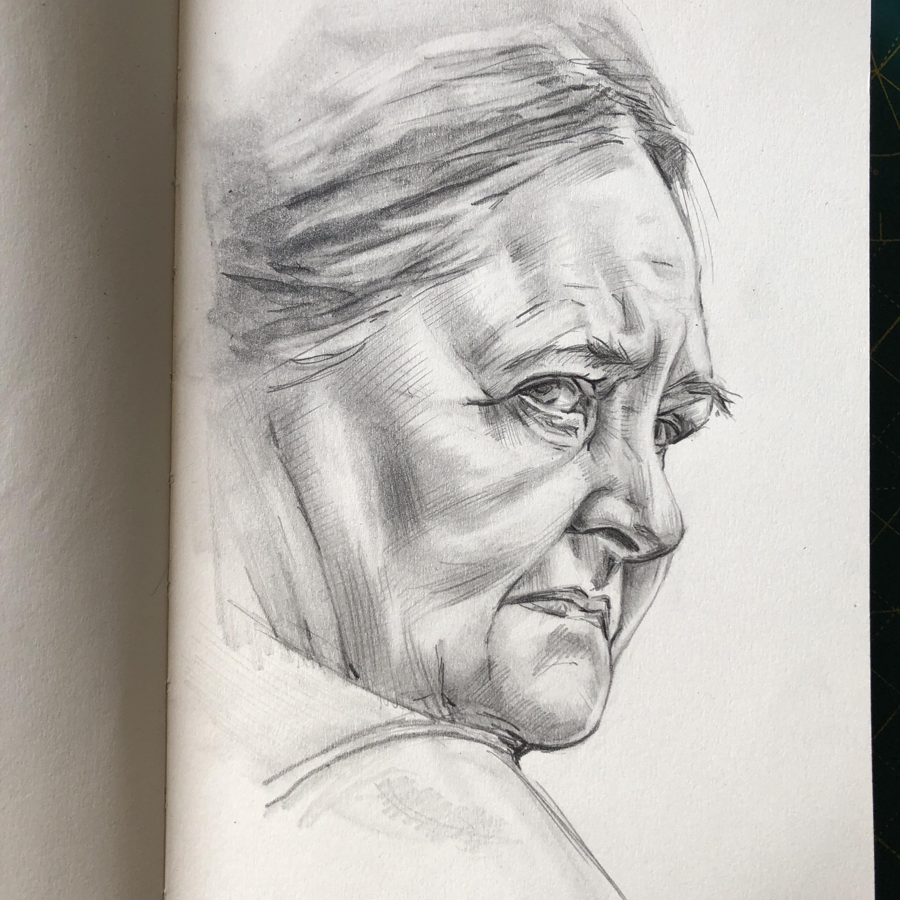 Portrait in a sketchbook of an elderly woman looking over her shoulder