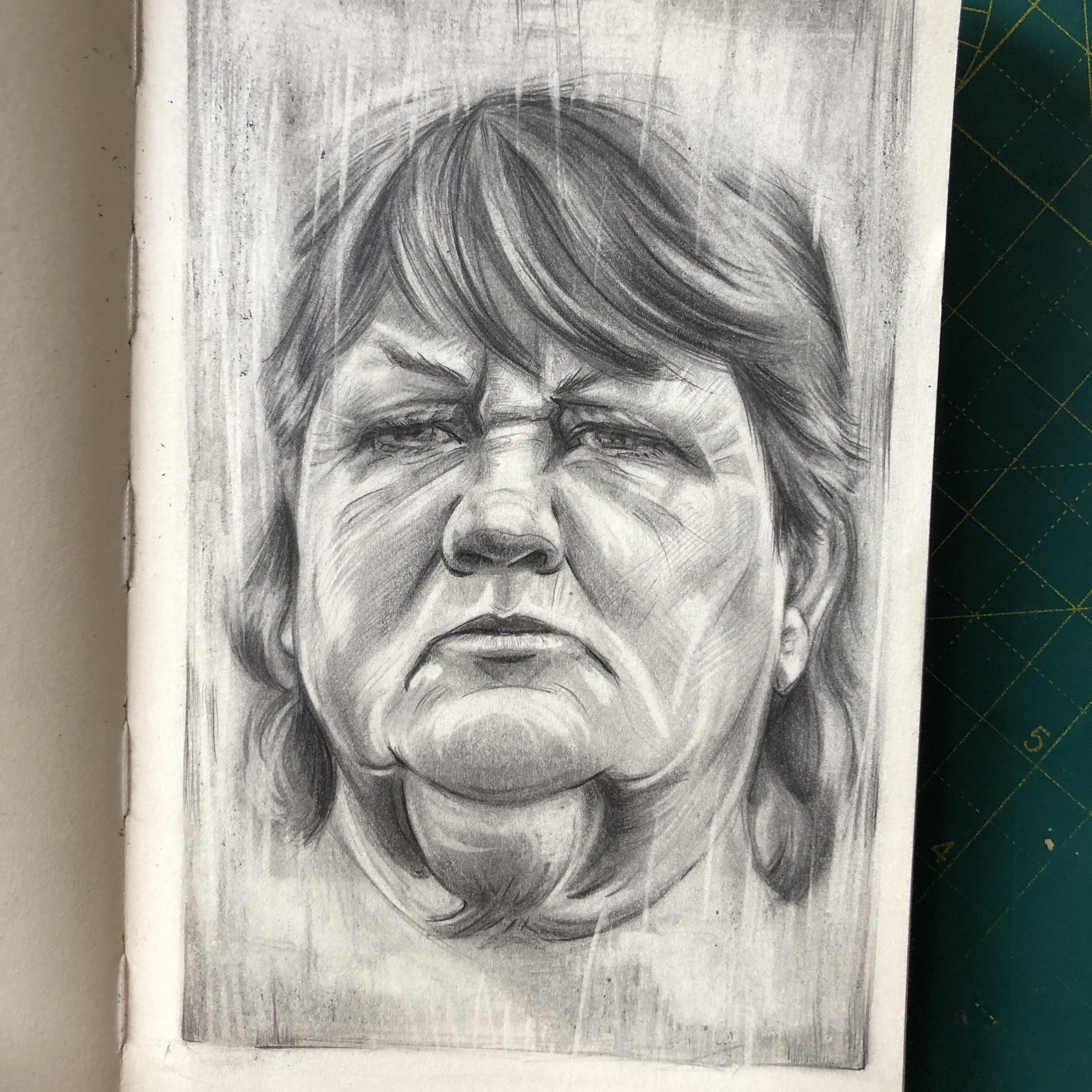 Portrait in graphite in a sketchbook. A woman is looking stern and like she’s about to blow.