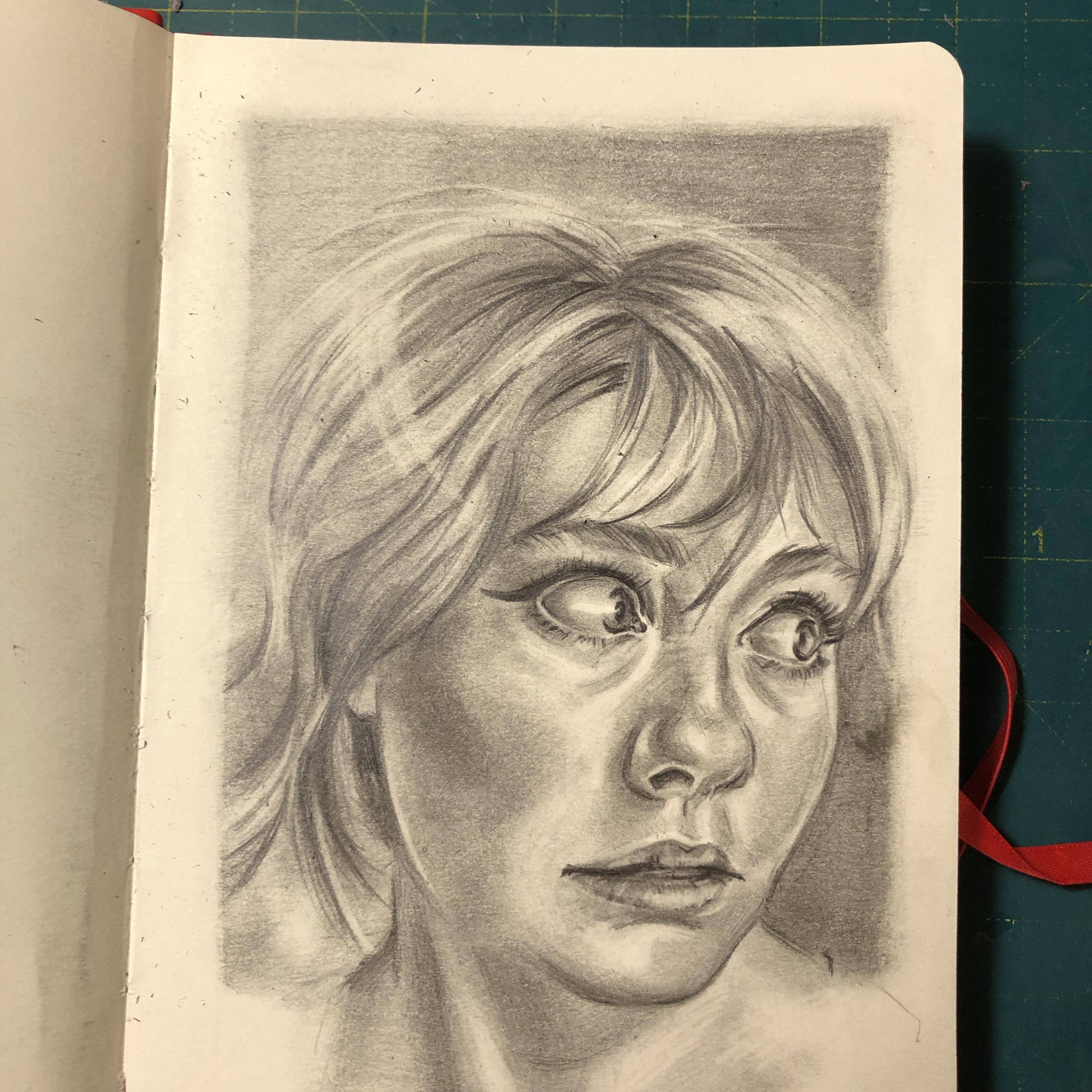 A light graphite portrait in a sketchbook. A young elfish woman is looking to the side