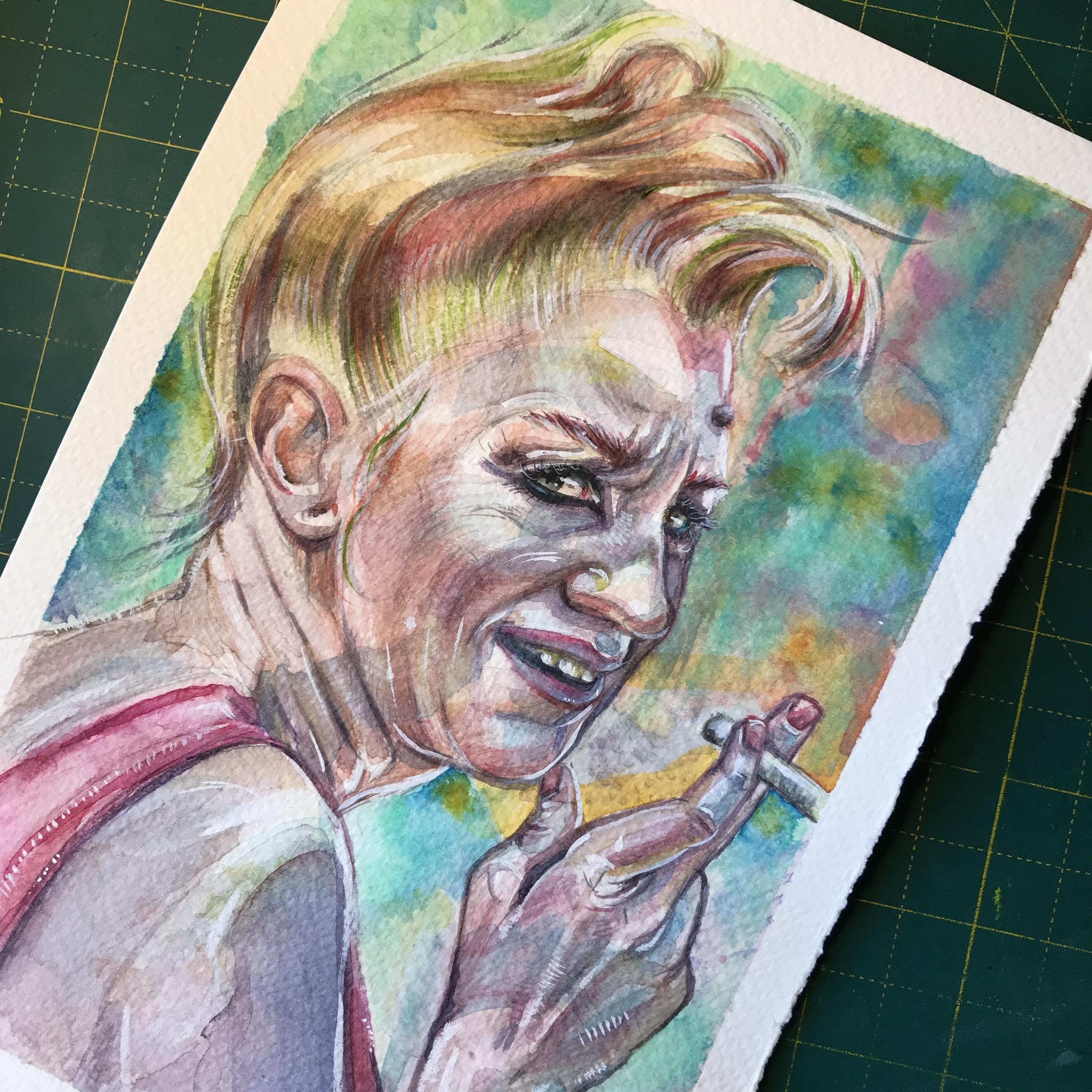 A very colorful watercolor portrait on white a5.
An elderly woman with a quiff and a spliff is looking over her shoulder at you. She looks rather feisty with a cigarette in her artithic hand