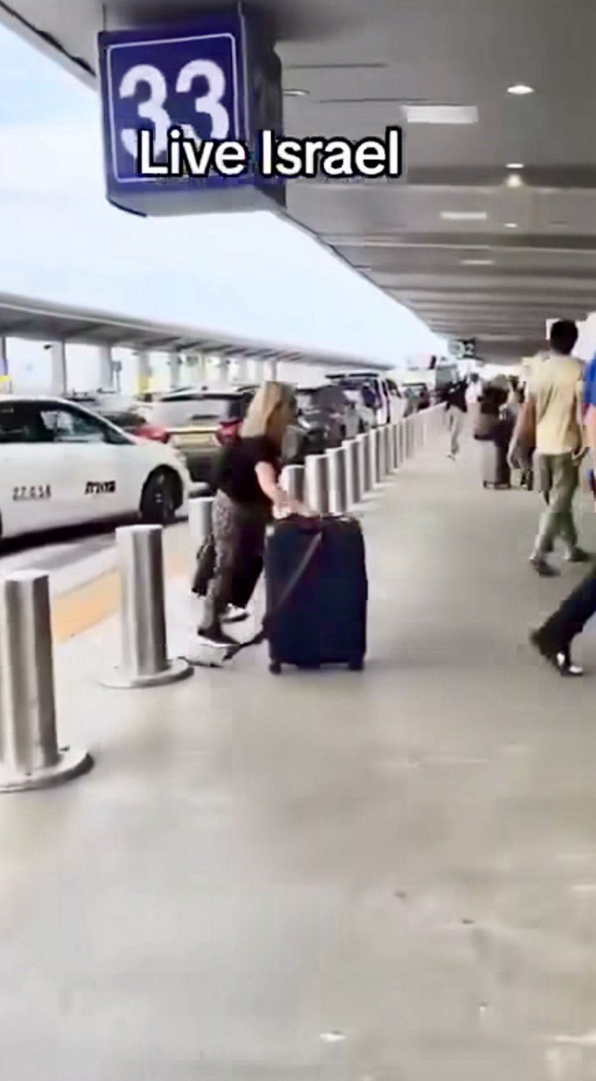 Airport in Israel where are running with suitcases, to leave the place.