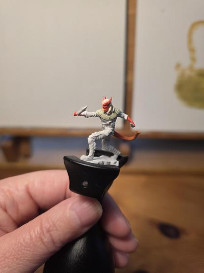 A tiefling miniature rouge, mostly unpainted.