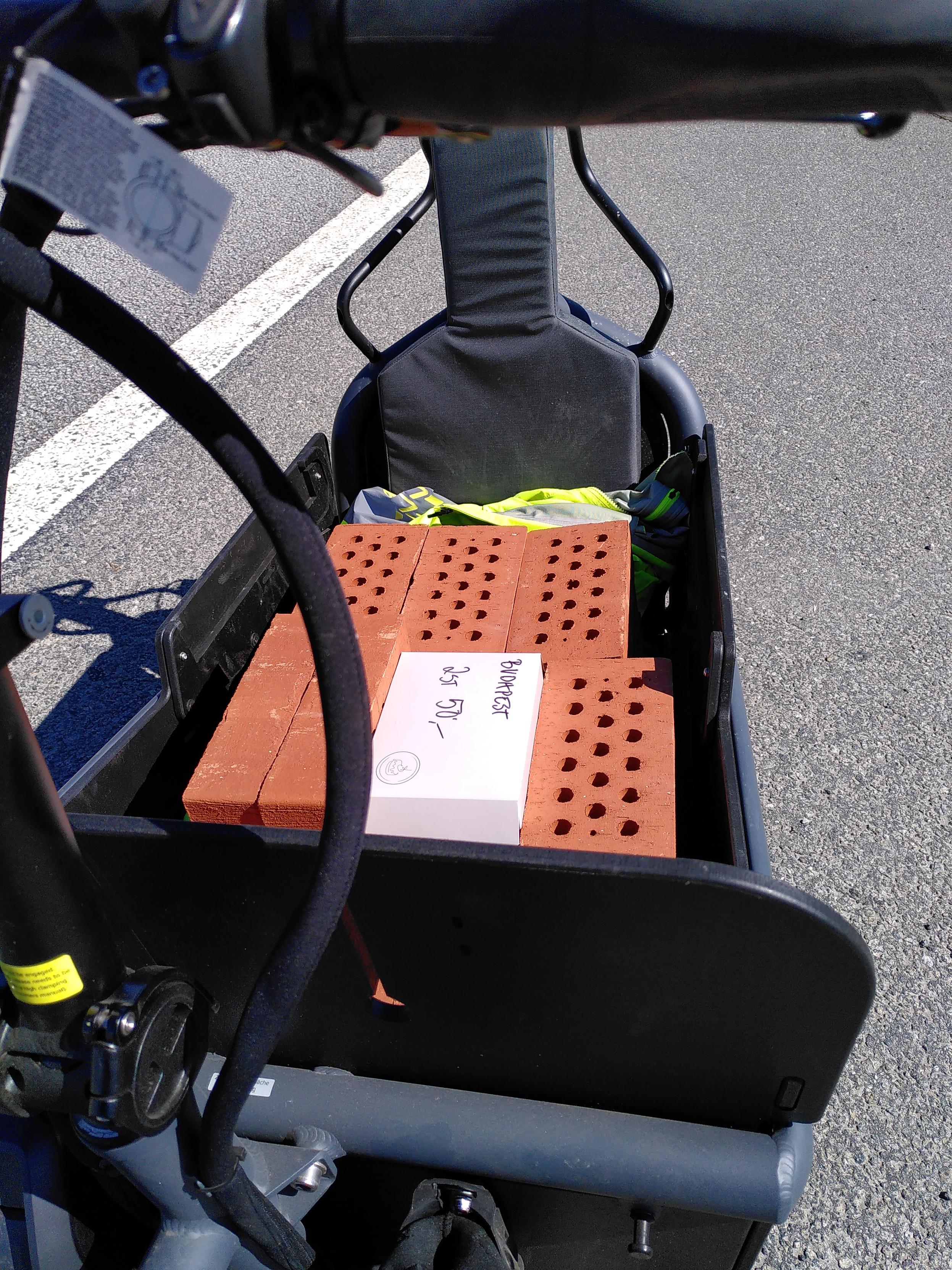 Cargo bike with 100 kilograms of brick and some Budapest roll pastries on top.