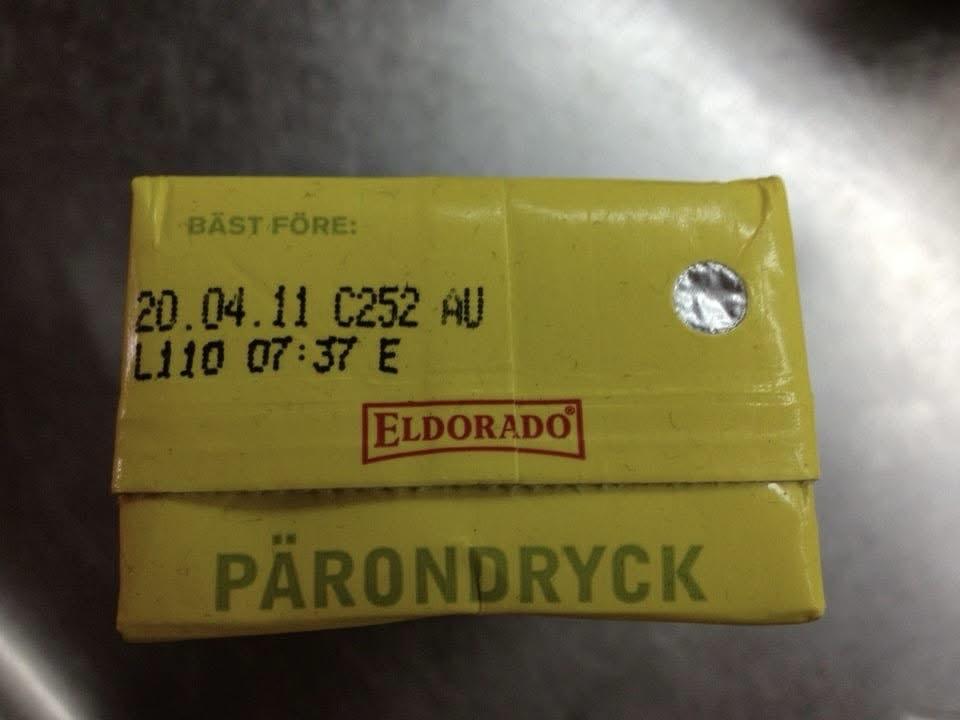 An image of a yellow juice carton with text indicating a best-before date and the brand name "Eldorado." The carton is labeled "Pärondryck," which translates to pear drink in Swedish.