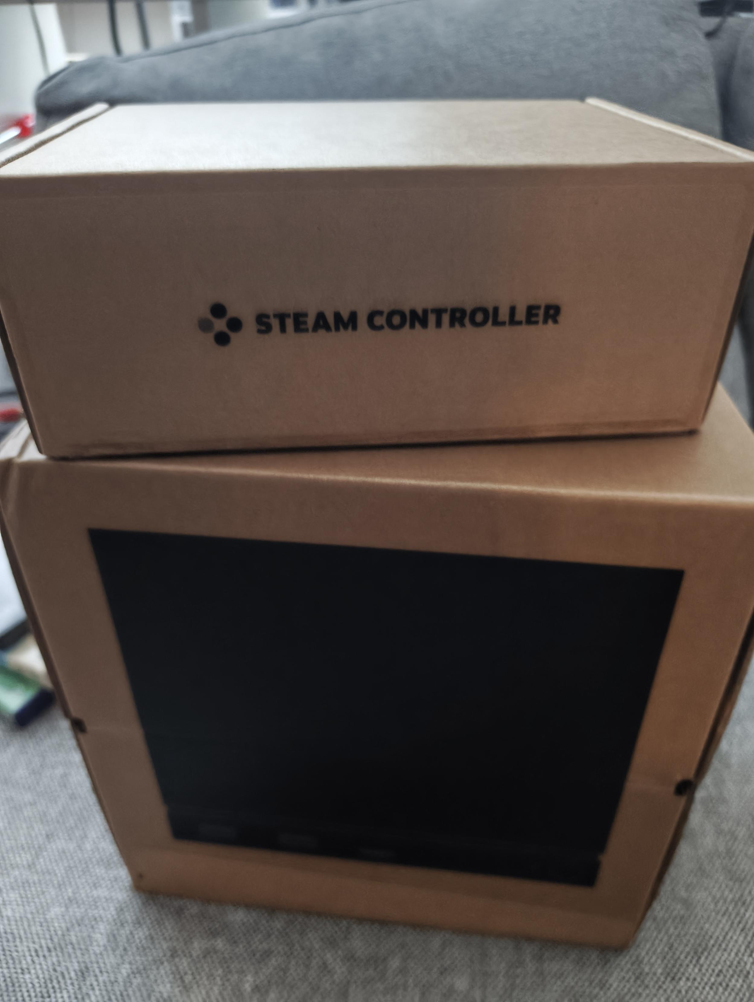 A Steam controller and a Steam machine in their cardboard packaging